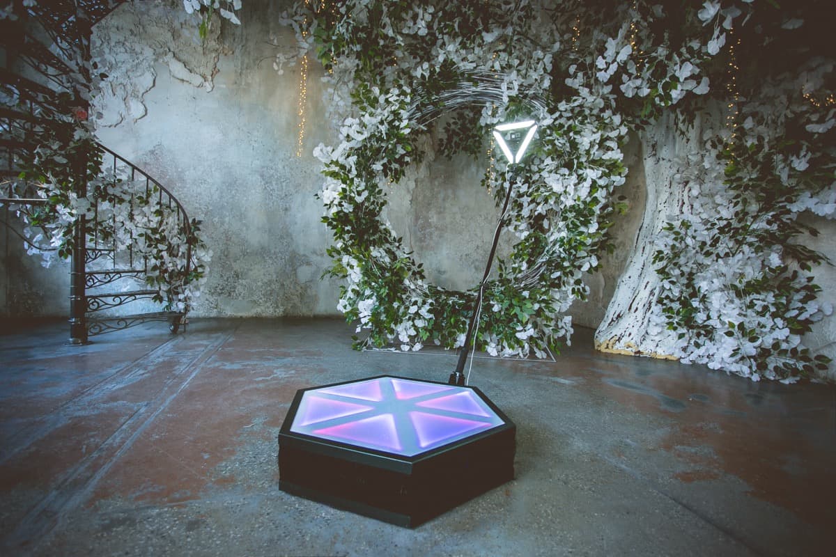 360 photo booth setup with floral arch at an awards ceremony