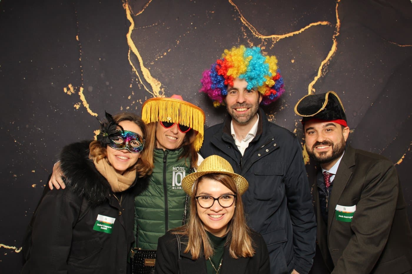 Group posing with props at the photo booth