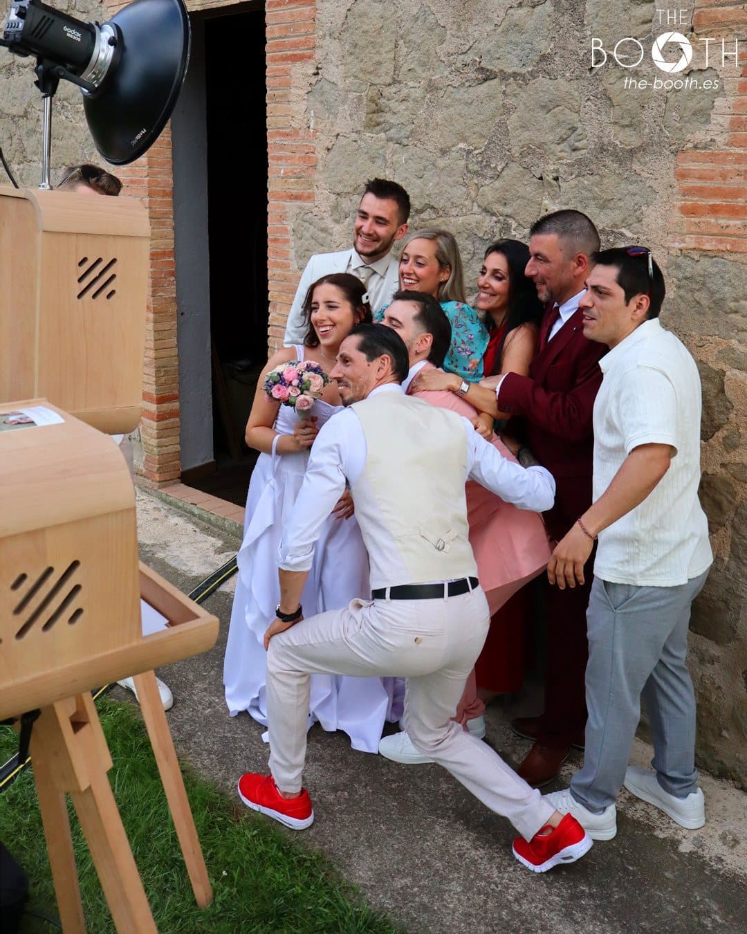 Guests using the vintage photo booth at a wedding